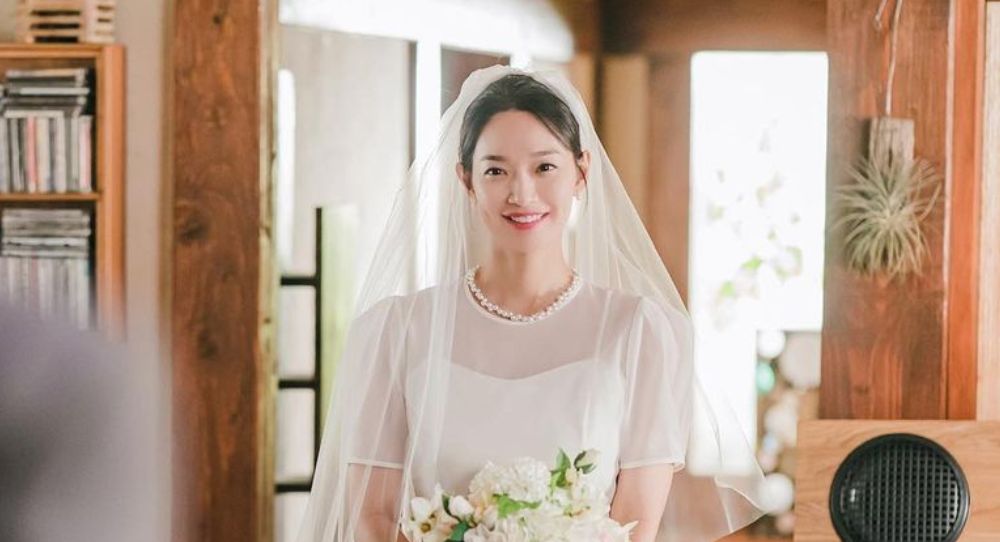 Shin Min Ah looks back at all the wedding dresses she wore in dramas and shares which one stands out most